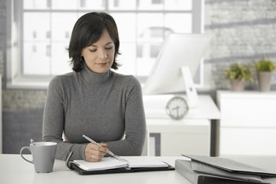 Business woman working on start-up checklist